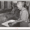 Homesteader's wife peeling potatoes for dinner. Pie Town, New Mexico