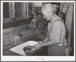 Homesteader's wife peeling potatoes for dinner. Pie Town, New Mexico