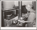 Mrs. George Hutton dishes up sausage made from her own hogs and canned last winter. Pie Town, New Mexico