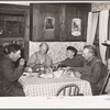 Mr. and Mrs. George Hutton, their son, and grandson at dinner. The younger Mr. Hutton homesteaded his own place, but he is now a widower and lives and farms with his father. Pie Town, New Mexico