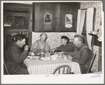 Mr. and Mrs. George Hutton, their son, and grandson at dinner. The younger Mr. Hutton homesteaded his own place, but he is now a widower and lives and farms with his father. Pie Town, New Mexico