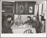 Mr. and Mrs. George Hutton, their son, and grandson at dinner. The younger Mr. Hutton homesteaded his own place, but he is now a widower and lives and farms with his father. Pie Town, New Mexico