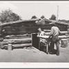 Mr. and Mrs. Faro Caudill bringing a table from their dugout. They are rebuilding their dugout nearer their water well, garden and stocklots. Pie Town, New Mexico
