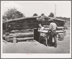 Mr. and Mrs. Faro Caudill bringing a table from their dugout. They are rebuilding their dugout nearer their water well, garden and stocklots. Pie Town, New Mexico
