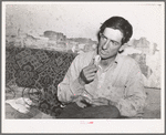 Faro Caudill, homesteader, rolling a cigarette. Pie Town, New Mexico