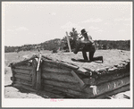 Pie Town, New Mexico. A community settled by about 200 migrant Texas and Oklahoma farmers who filed homestead claims. Faro Caudill taking down the chimney from his dugout before he tears down the dugout