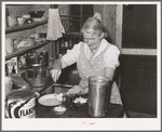 Mrs. Holley, Sr., dishing up ice cream. Pie Town, New Mexico
