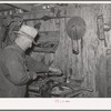 George Hutton Sr., in the machine shop on his farm. Pie Town, New Mexico