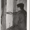 George Hutton, Jr., papering the kitchen for his mother. Pie Town, New Mexico
