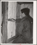 George Hutton, Jr., papering the kitchen for his mother. Pie Town, New Mexico