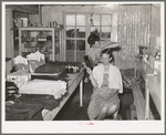 A neighbor fixes the grocery clerk's hair at Pie Town, New Mexico