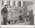 Mr. Craig handing sackful of nails to a farmer. Pie Town, New Mexico