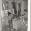 Josie Caudill, homesteader's daughter, combs her hair. Pie Town, New Mexico