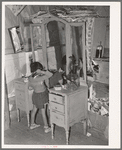 Josie Caudill, homesteader's daughter, combs her hair. Pie Town, New Mexico