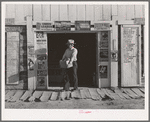 Mr. Keele, merchant and president of the Farm Bureau, in front of the general store. Pie Town, New Mexico