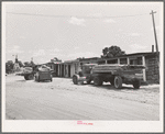 Trucks from a small sawmill stand in front of the cabins at Pie Town, New Mexico
