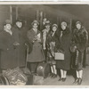 Ballet Russes dancers with Serge Diaghilev standing in front of train with luggage