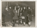 Ballet Russes dancers with Serge Diaghilev standing in front of train with luggage