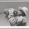 Member of the Casa Grande Valley Farms, Pinal County, Arizona, drinking from water bottle while in the hay field