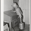 Writing down weight of milk given by one cow at the Casa Grande Valley Farms. Pinal County, Arizona. Exact and completed milk records are kept on all dairy cows