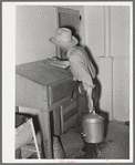 Writing down weight of milk given by one cow at the Casa Grande Valley Farms. Pinal County, Arizona. Exact and completed milk records are kept on all dairy cows