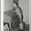 Writing down weight of milk given by one cow at the Casa Grande Valley Farms. Pinal County, Arizona. Exact and completed milk records are kept on all dairy cows