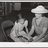 Reading the lesson from the Bible at the Sunday school at the Community house of the Casa Grande Valley Farms. Pinal County, Arizona