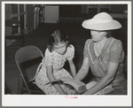 Reading the lesson from the Bible at the Sunday school at the Community house of the Casa Grande Valley Farms. Pinal County, Arizona