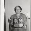 Wife of member of the Casa Grande Valley Farms, displaying canned goods with which she won prizes at the state fair. Pinal County, Arizona