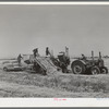 Hay picker-up and chopper at the Casa Grande Valley Farms. Pinal County, Arizona