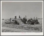 Hay picker-up and chopper at the Casa Grande Valley Farms. Pinal County, Arizona