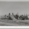 Hay picker-up and chopper at the Casa Grande Valley Farms. Pinal County, Arizona