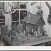 Little red schoolhouse modeled from schoolday memories of Homer Tate. Safford, Arizona. Mr. Tate is a self-trained artist working in papier mache and such indigenous materials as cactus, bone, wood and stone