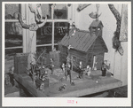 Little red schoolhouse modeled from schoolday memories of Homer Tate. Safford, Arizona. Mr. Tate is a self-trained artist working in papier mache and such indigenous materials as cactus, bone, wood and stone