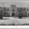 One of the main buildings with town square in foreground of the Burro Mountain Copper Company, now inactive, at Tyrone, New Mexico