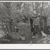 Eugene Davis, gold prospector, coming out of his shack home at his diggings at Pinos Altos, New Mexico