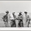 Mr. Thayne, cooperative specialist of FSA, presenting check to the three Ericson brothers to buy a cooperative tractor. Box Elder County, Utah