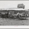 Members of FSA cooperative manure spreader loading the spreader. Box Elder County, Utah