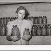 Wife of Mormon farmer with canned goods. Snowville, Utah