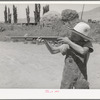 Mormon farm boy shooting air rifle. Box Elder County, Utah