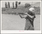 Mormon farm boy shooting air rifle. Box Elder County, Utah