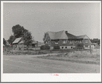 Houses belonging to a Mormon farmer in Mendon, Utah. The new house was built with profits from his farm