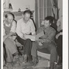 FSA county supervisor, center, looks over the books of the FSA cooperative stallion organization. Box Elder County, Utah