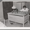 Spanish-American boy working at desk which he made. Notice the similarity in the design of the desk to that of the vigas in the ceiling. Chamisal, New Mexico