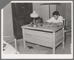 Spanish-American boy working at desk which he made. Notice the similarity in the design of the desk to that of the vigas in the ceiling. Chamisal, New Mexico