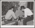 Spanish-American boy sharpening knife. Chamisal, New Mexico