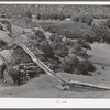 Irrigation water crossing ditch in hollowed out log. Trampas, New Mexico
