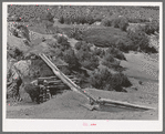 Irrigation water crossing ditch in hollowed out log. Trampas, New Mexico