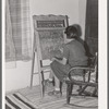Spanish-American girl who is learning English with the aid of blackboard instruction. Chamisal, New Mexico