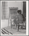 Spanish-American girl who is learning English with the aid of blackboard instruction. Chamisal, New Mexico